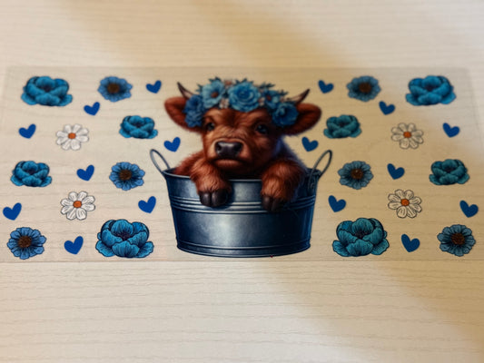 Highland cow with blue flowers and daisies